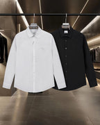 Burberry long-sleeve button-up shirts, white and black on display