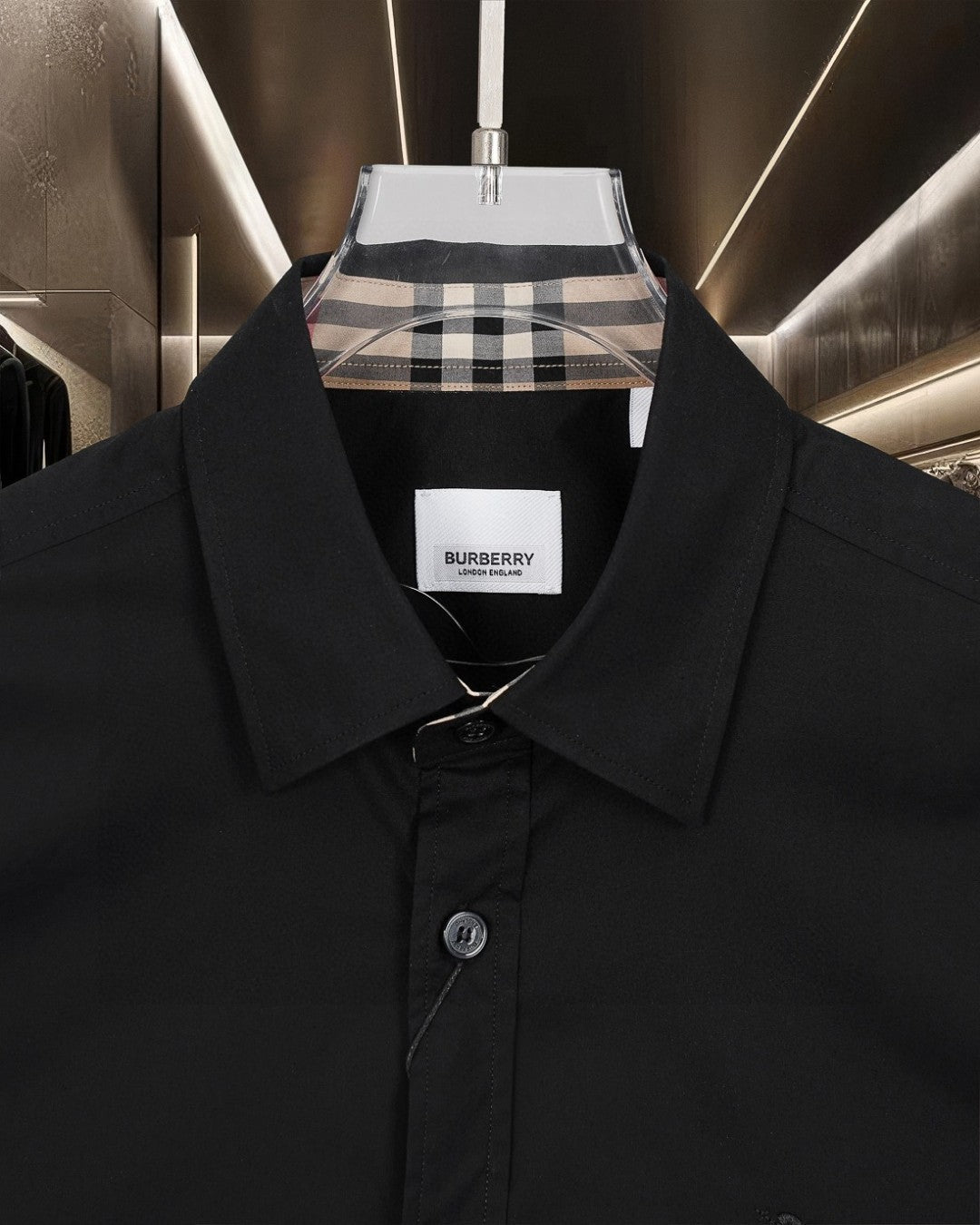 Black button-up shirt with pointed collar and visible front buttons; Burberry label