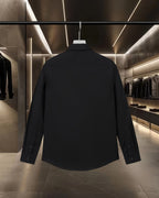 Black long-sleeve button-up shirt, back view with long sleeves and button cuffs