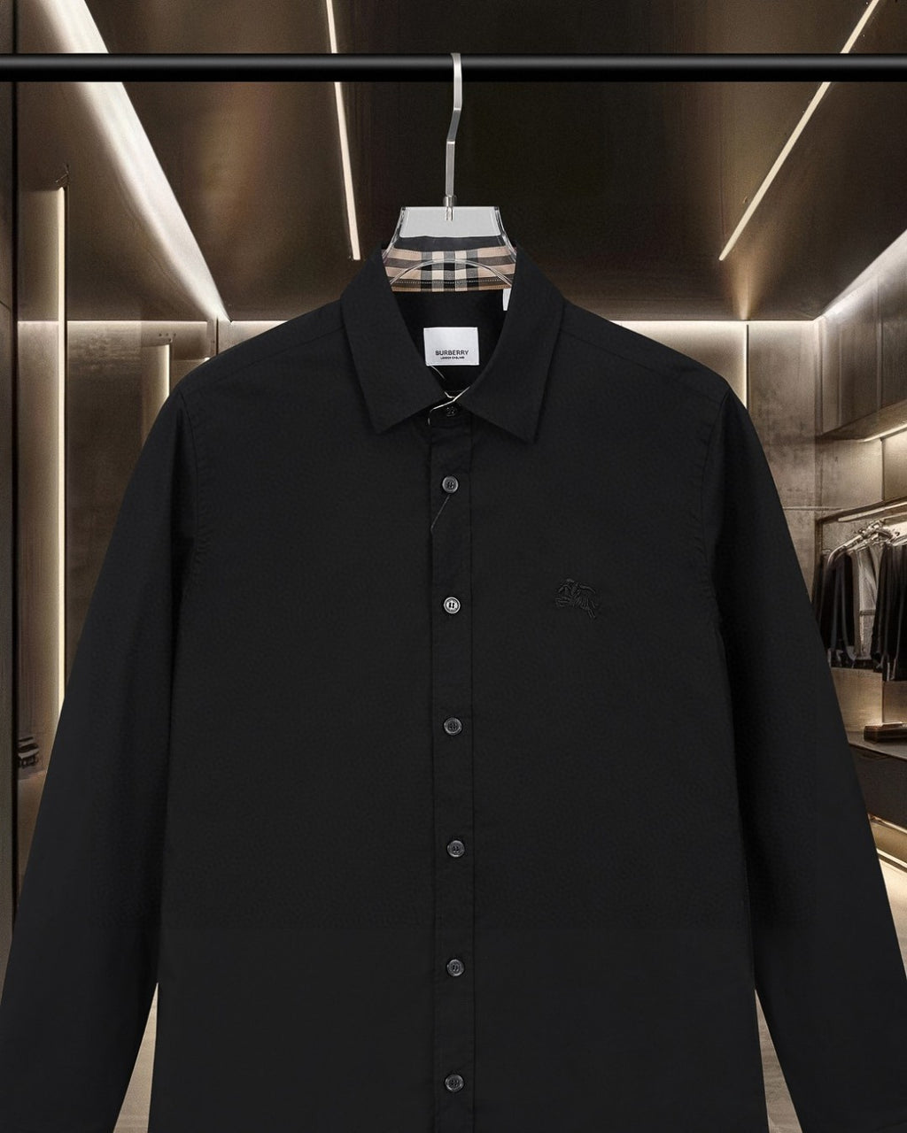 Black long-sleeve shirt with pointed collar and buttoned front; small chest logo