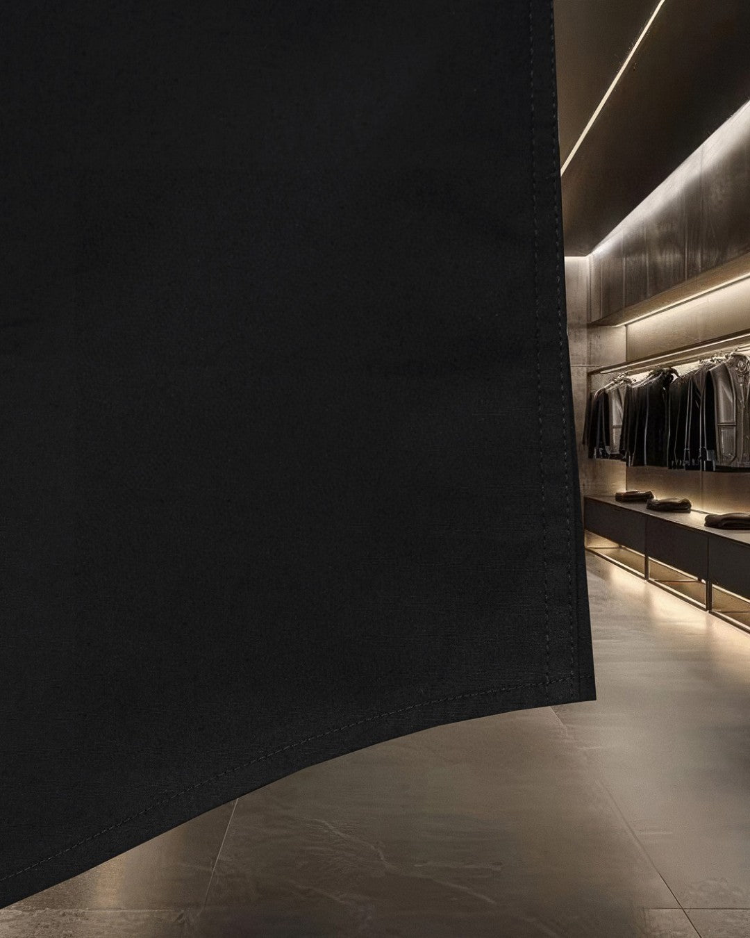 Dark long-sleeve shirt with curved hem and stitched edge