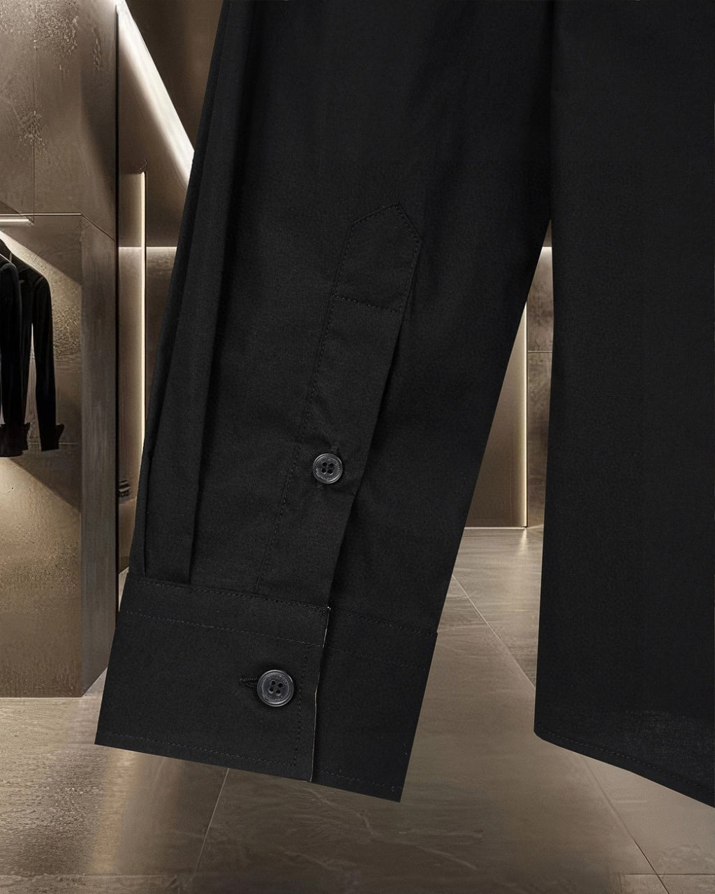 Dark long-sleeve shirt with buttoned front and two visible buttons