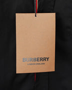 Burberry clothing tag on dark black long-sleeve shirt, London England