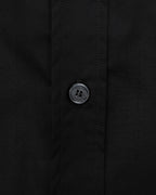 Burberry long-sleeve shirt cuff button close-up, dark black