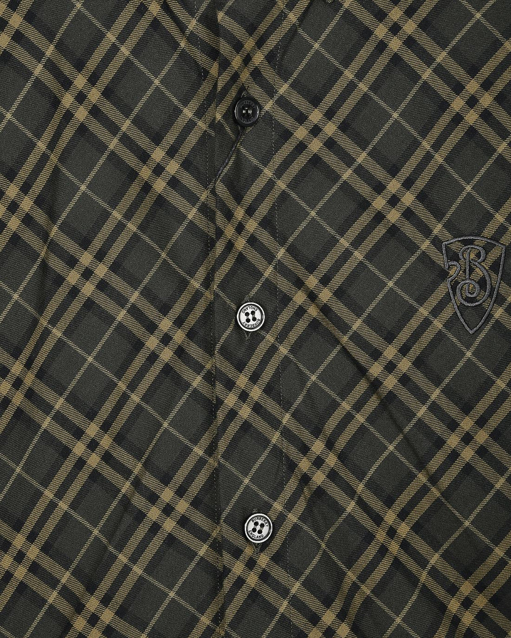 Burberry plaid button-up shirt detail, dark green fabric with yellow grid and crest patch