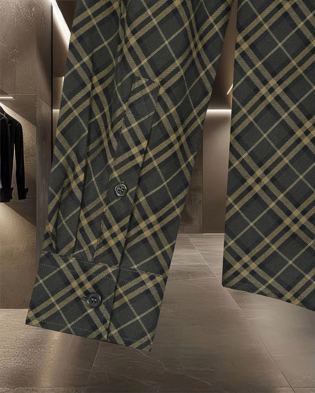 Plaid button-up shirt sleeve and hem, dark green and yellow grid pattern, button detail