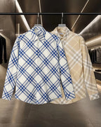 Blue and beige plaid long-sleeve button-up shirts on hangers