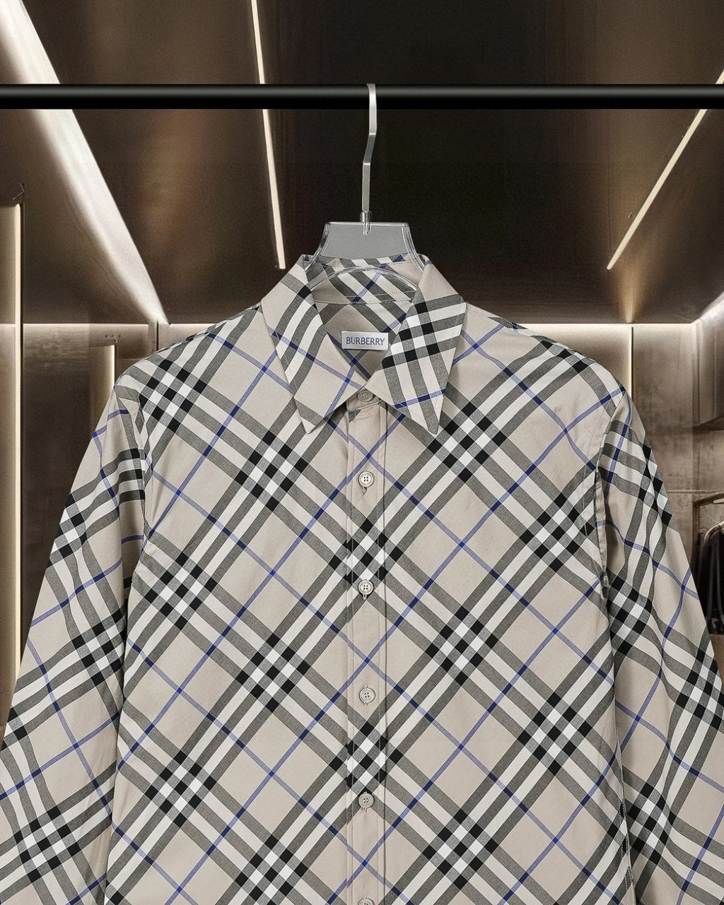 Long-sleeve button-up check shirt, close-up front with button placket and collar