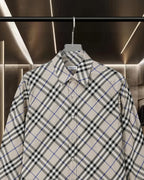 Long-sleeve button-up check shirt, close-up front with button placket and collar