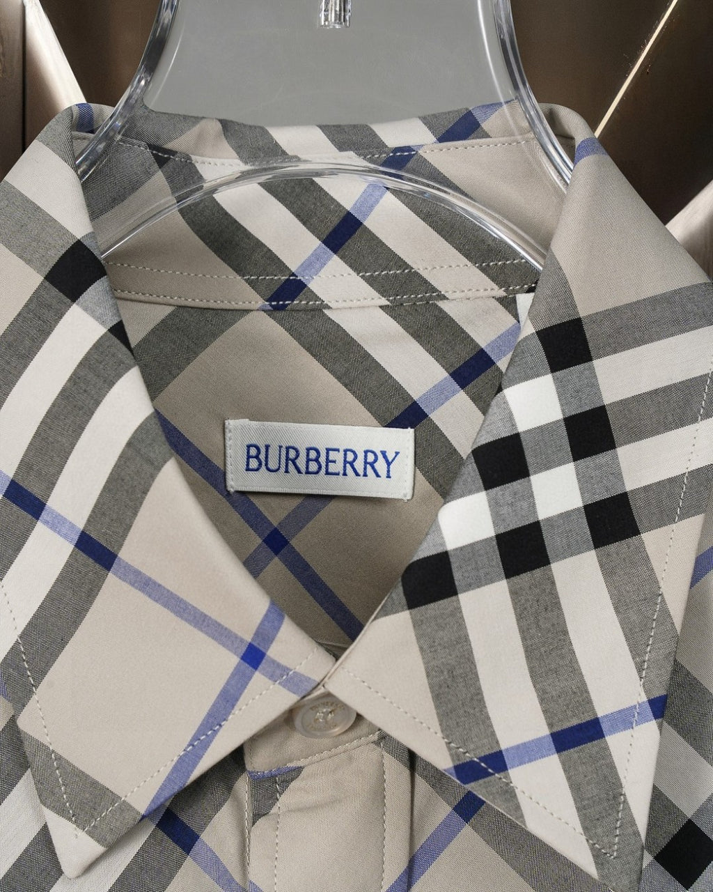 Long-sleeve check shirt collar and label, white label on black and blue plaid