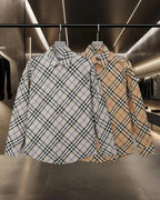 Long Burberry plaid shirts on hangers, collared button front, blue and red checks