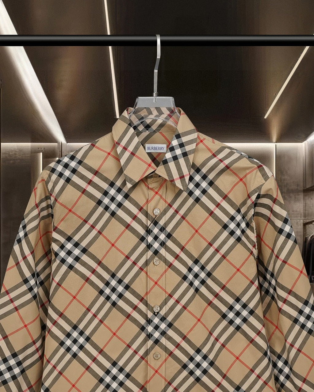 Burberry plaid button-up shirt close-up: pointed collar and button placket on beige base