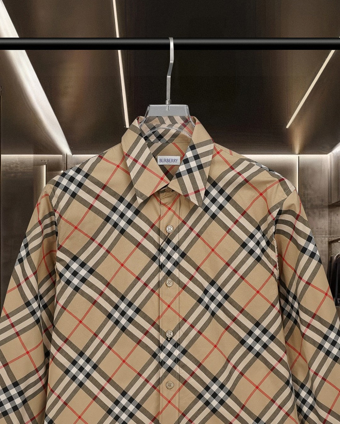 Burberry plaid button-up shirt close-up: pointed collar and button placket on beige base
