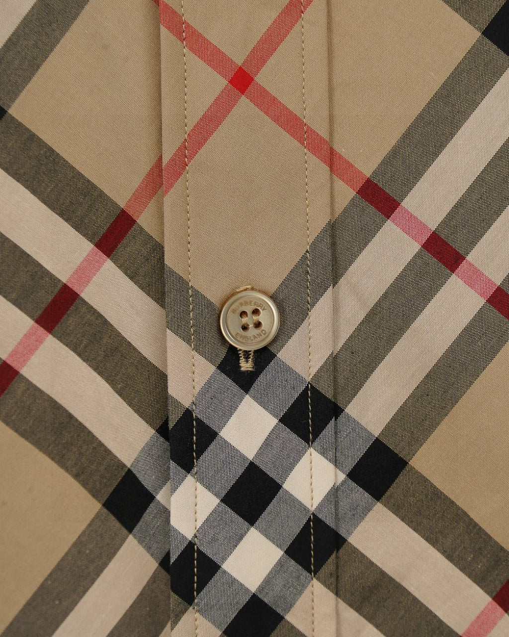 Burberry plaid shirt front placket detail with three buttons on beige and black checks