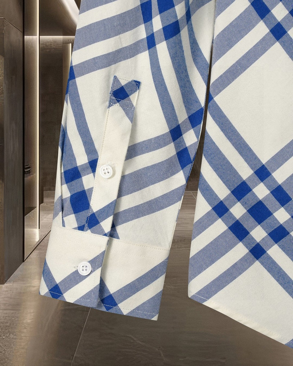 Plaid shirt front with pocket detail and button at cuff, blue and white