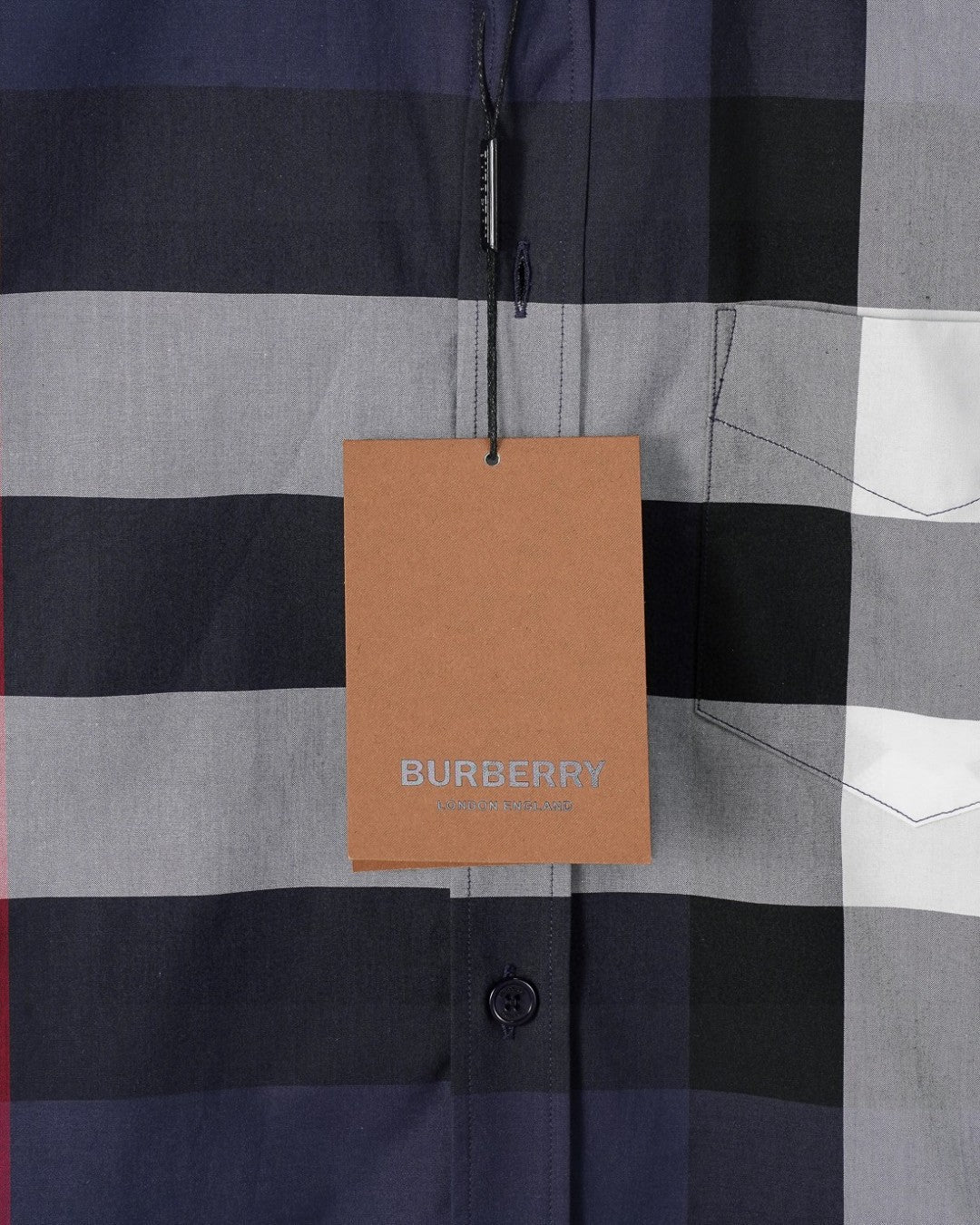 Burberry plaid shirt with hanging tan BURBERRY tag and front button closure