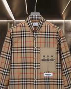 Long-sleeve plaid button-up shirt with chest pocket and beige logo patch