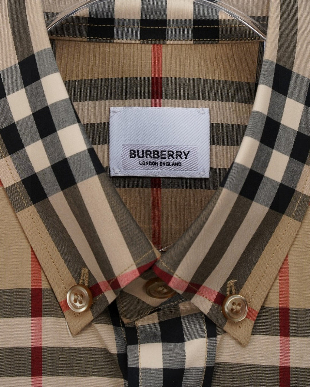 Plaid button-up collar with gold-tone buttons and interior neck label