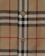 Plaid shirt front placket with gold-tone buttons