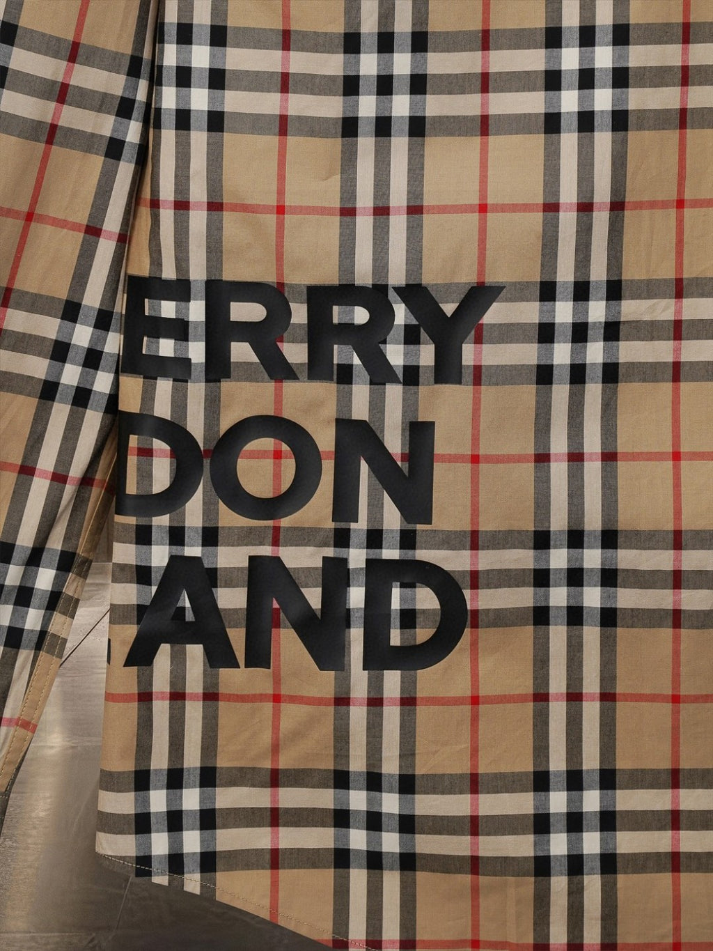 Burberry plaid button-up shirt with large black text logo on front