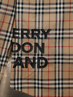 Burberry plaid button-up shirt with large black text logo on front