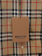 Burberry plaid shirt size tag hanging at front placket