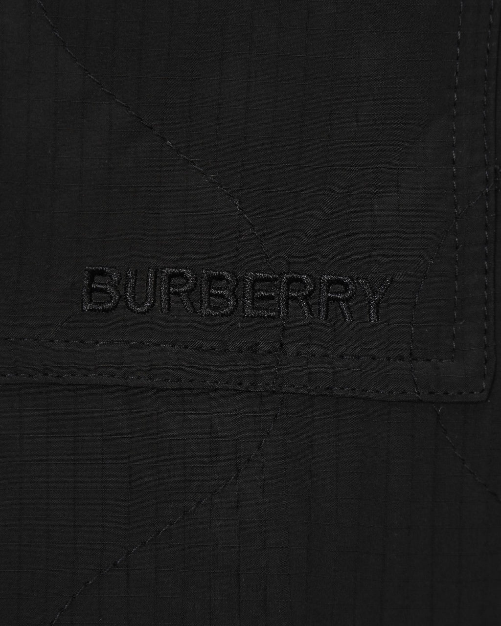 Burberry long coat pocket logo embroidery 'BURBERRY' on black fabric