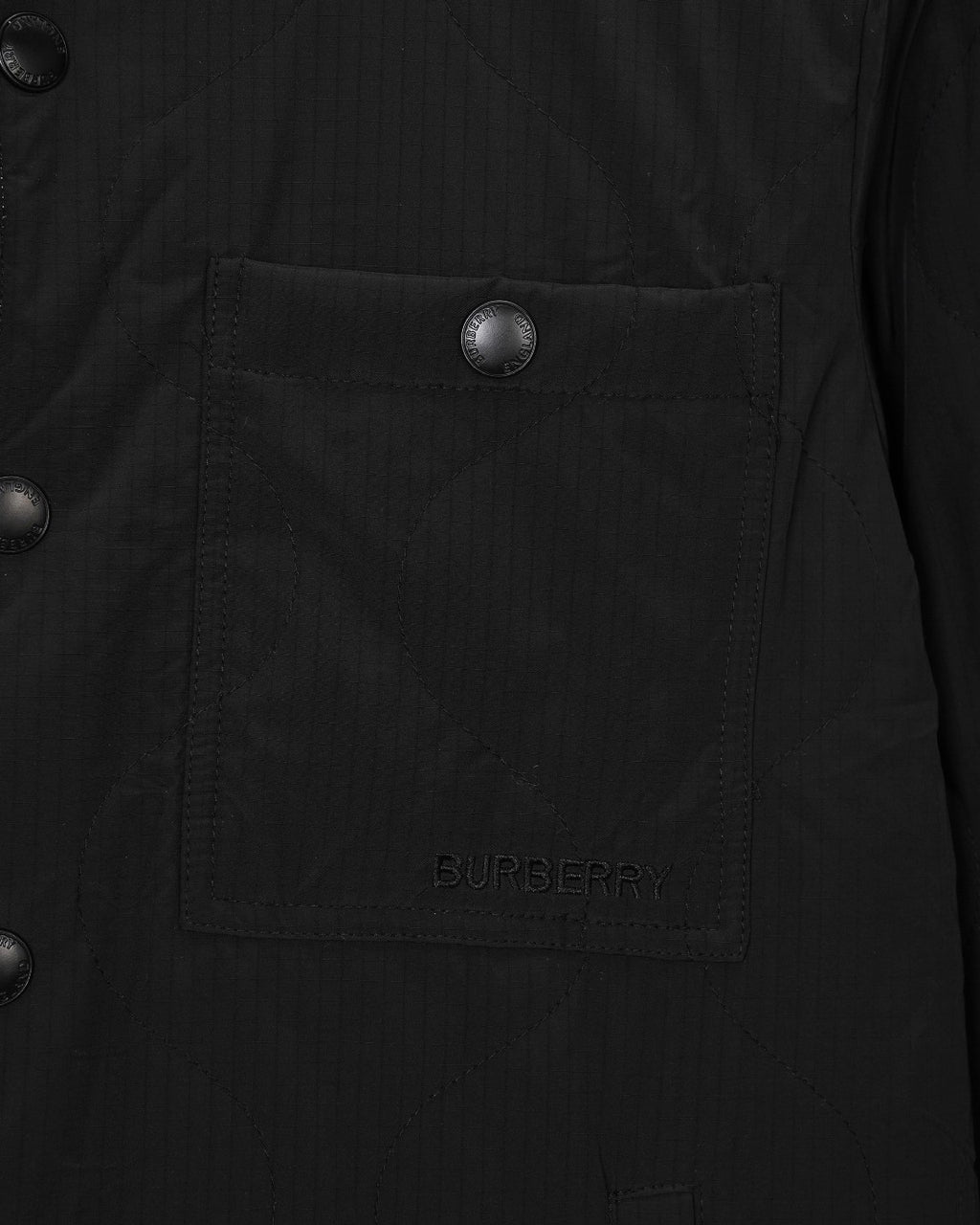 Burberry long coat pocket close-up with embossed button and BURBERRY embroidery
