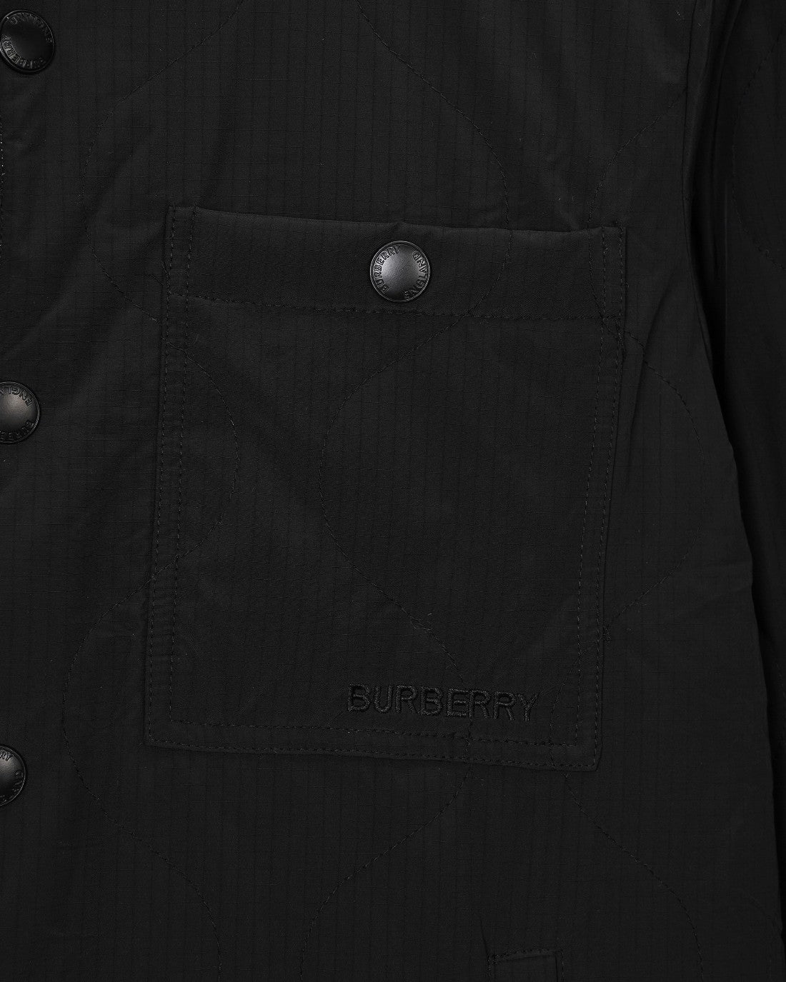 Burberry long coat pocket close-up with embossed button and BURBERRY embroidery