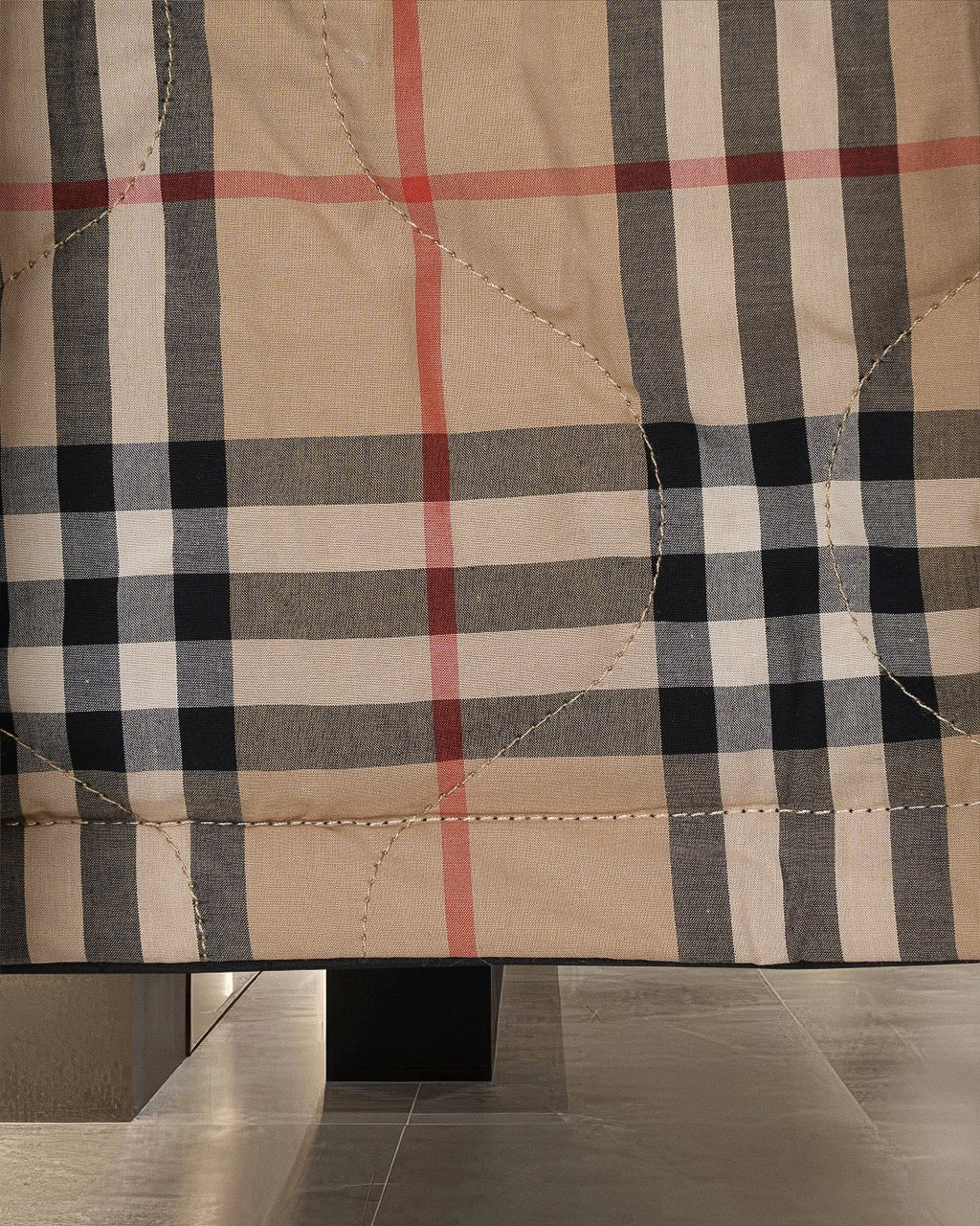 Plaid long coat fabric in beige with black and red check pattern and detailed stitching
