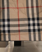 Plaid long coat fabric in beige with black and red check pattern and detailed stitching