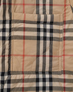 Plaid quilted jacket midsection with rectangular patch stitching and beige, black, and red lines.
