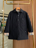 Black long button-up jacket with plaid-lined cuffs and two chest pockets