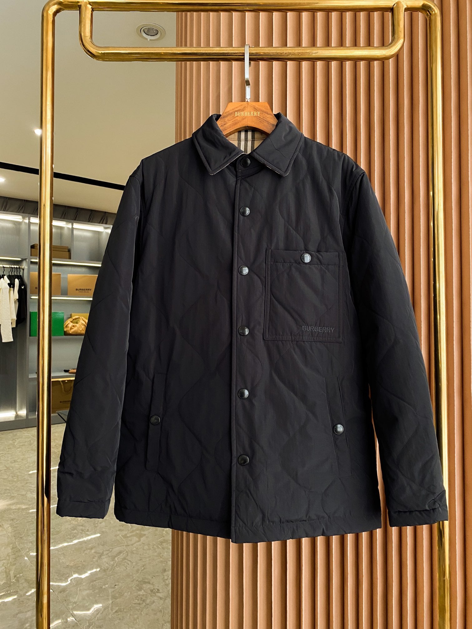 Black long coat jacket with spread collar, button front, and chest pocket