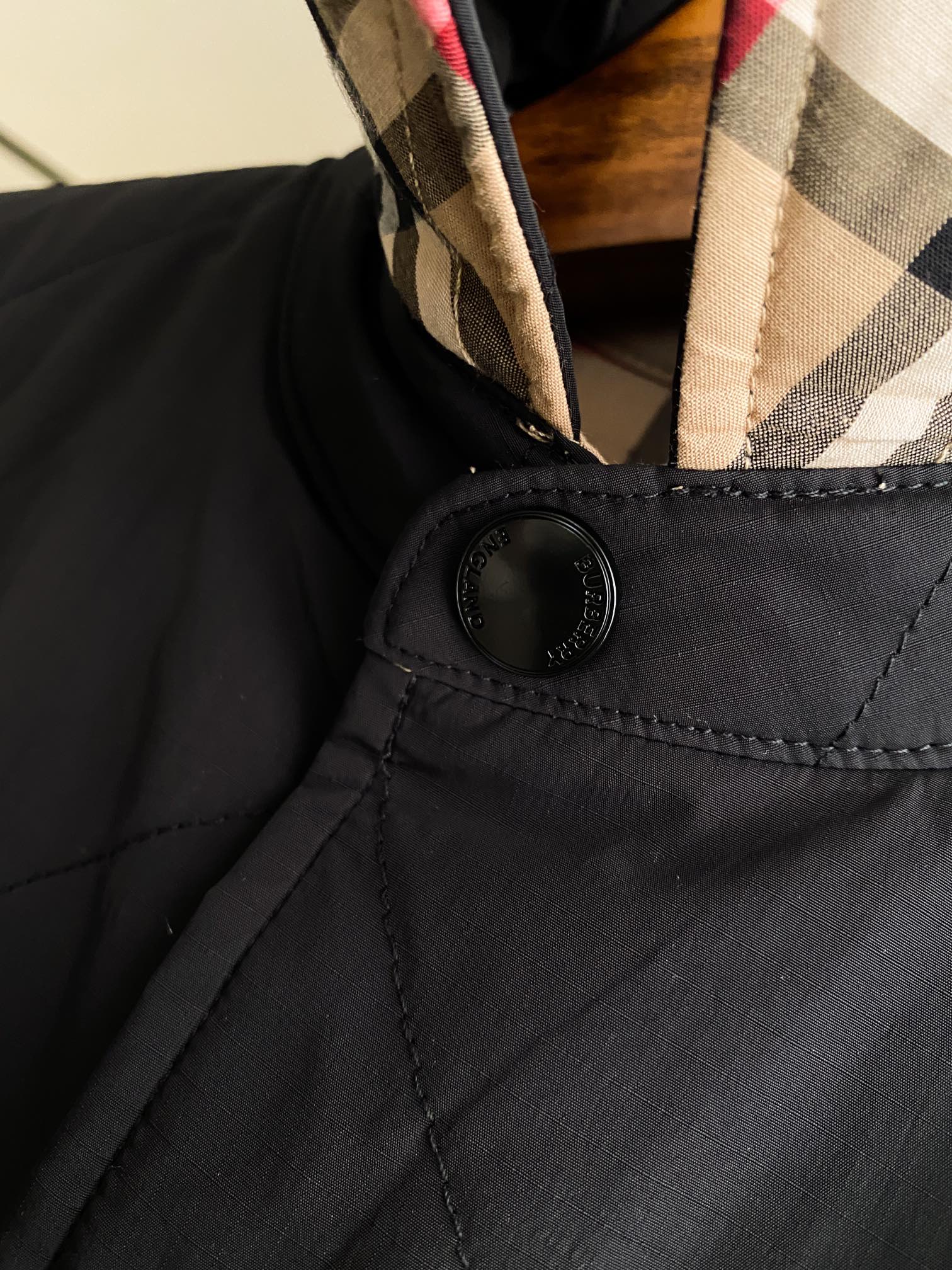 Black jacket chest placket with round button and stitched flap pocket
