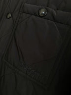 Black jacket panel with quilted stitching and Burberry logo patch
