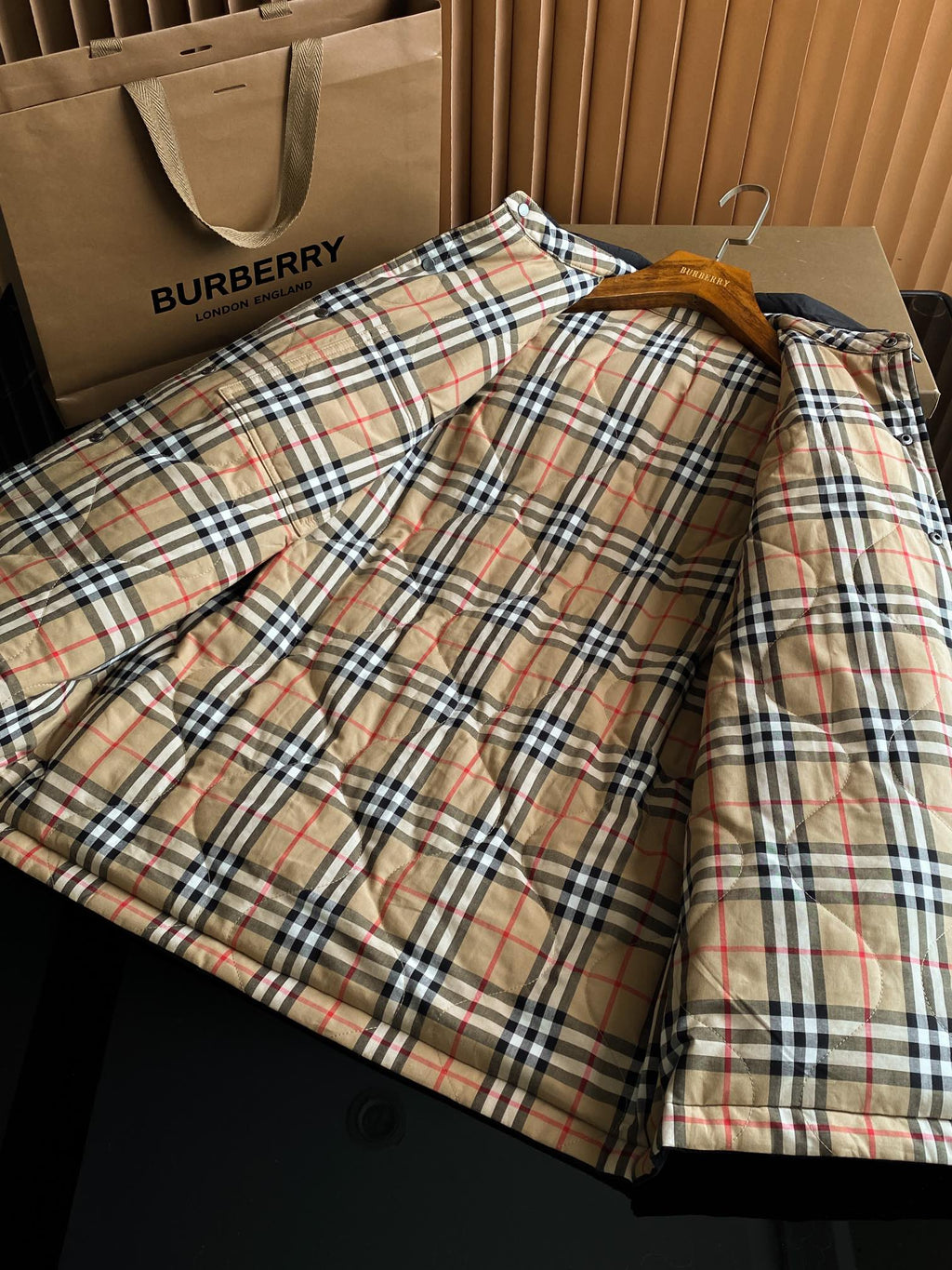 Long jacket with plaid lining and button-front placket, shown laid open