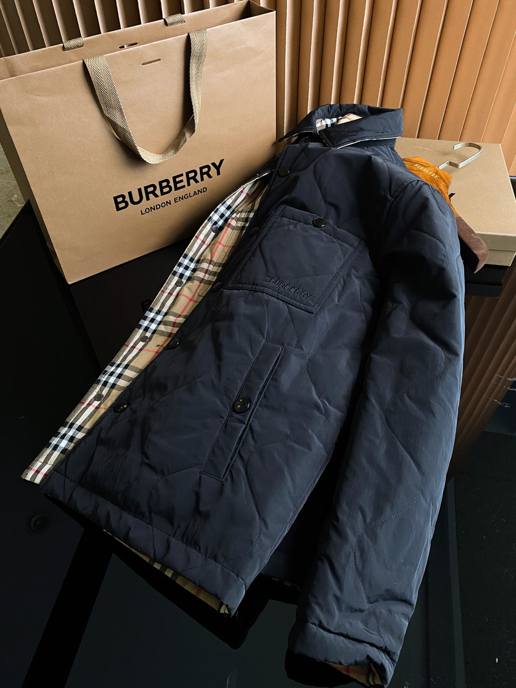 Navy or black long jacket with patch pocket flap and plaid cuff lining