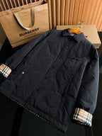 Black long jacket with button front, chest flap pocket, and plaid cuff