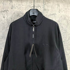 Black Balenciaga zip-up jacket with high collar, drawstrings, and oval chest logo.