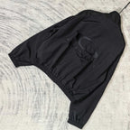Black Balenciaga zip-up jacket laid flat with back logo graphic and elastic waistband.