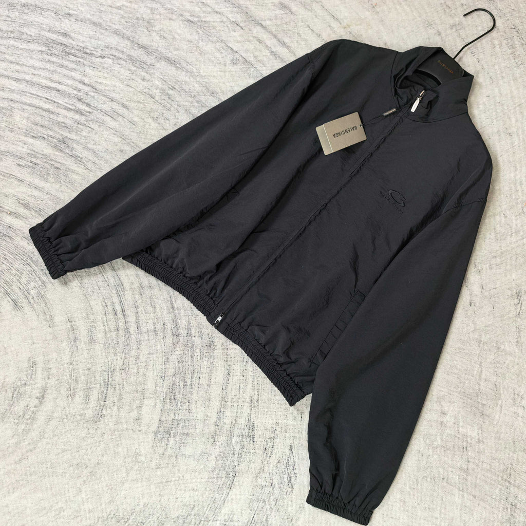 Black Balenciaga zip-up jacket laid flat with front zipper and elastic cuffs.
