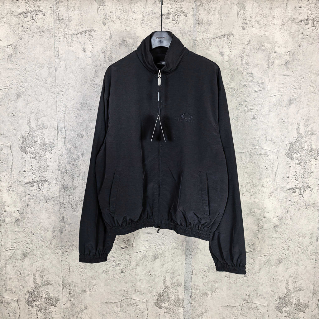 Black Balenciaga zip-up jacket with drawstring hood and elastic cuffs.