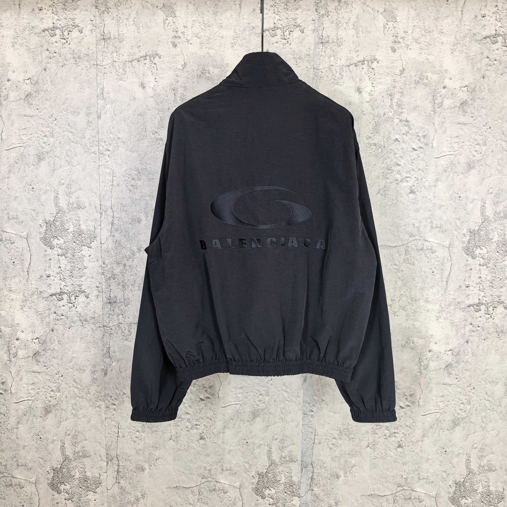 Black Balenciaga zip-up jacket with oval logo print on the back.