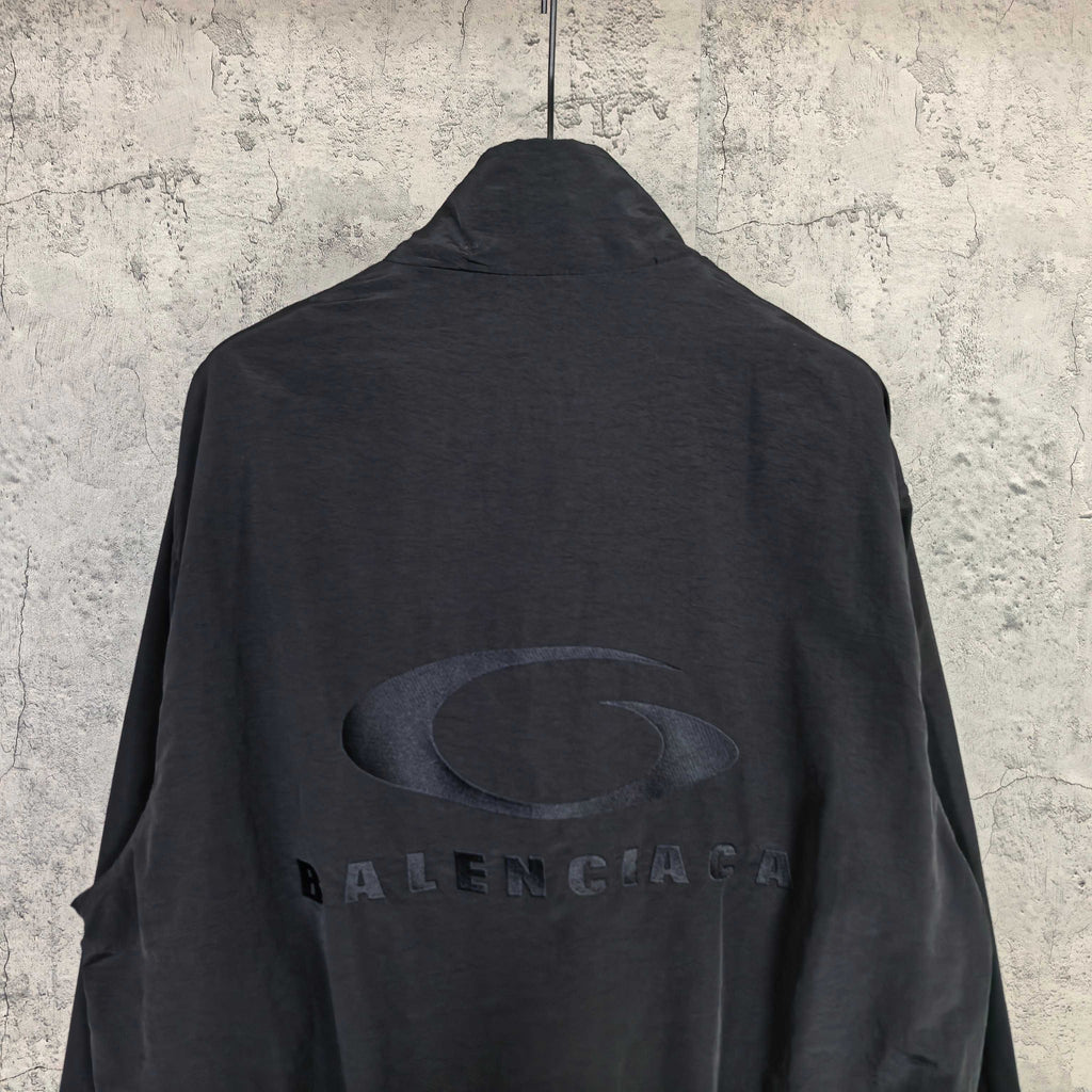 Black Balenciaga zip-up jacket back with large oval logo and BALENCIAGA lettering.