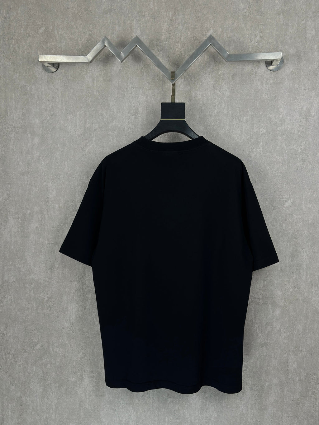 Balenciaga short-sleeve T-shirt in black, plain back view on hanger