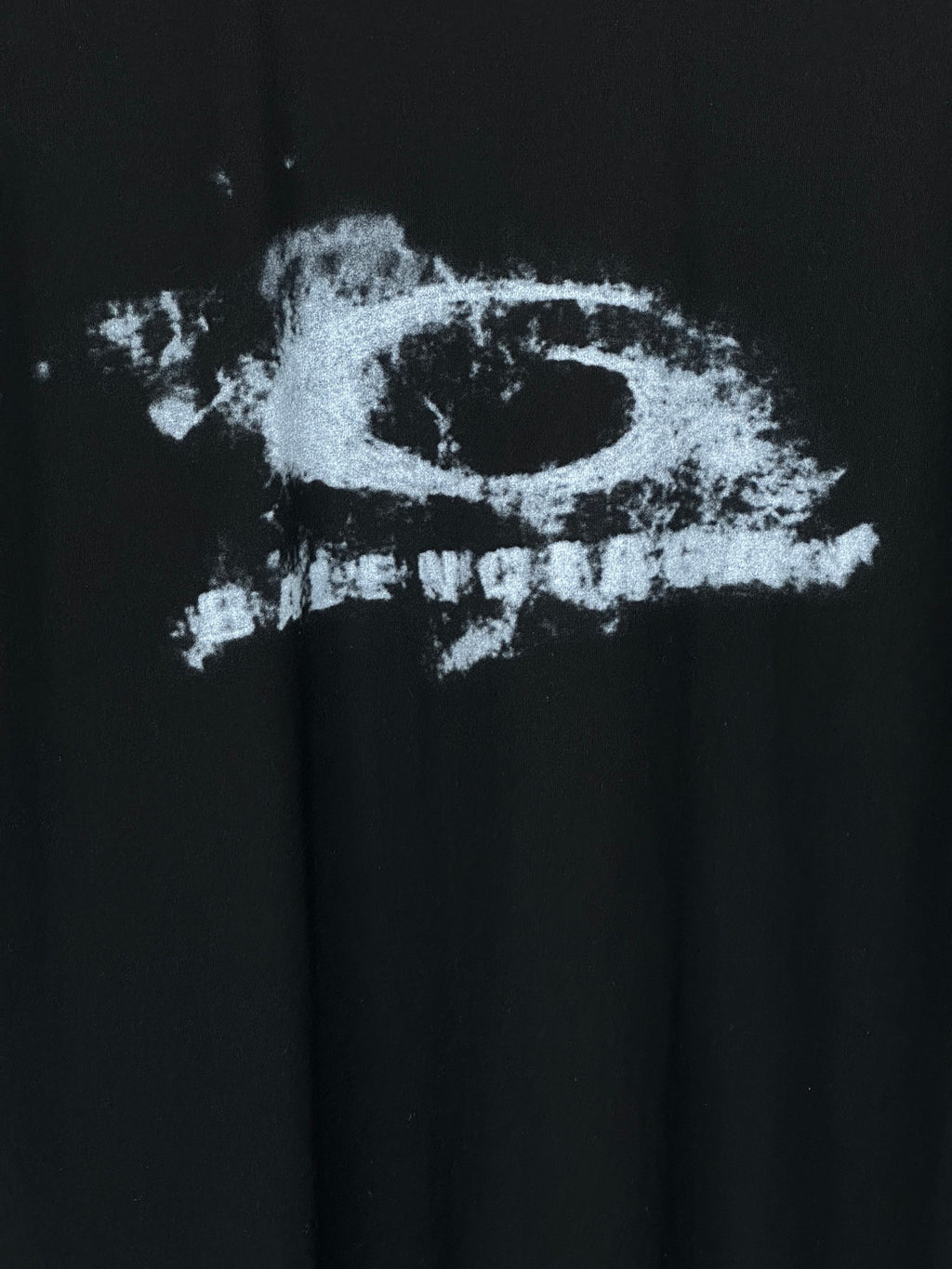 Balenciaga short-sleeve T-shirt detail: distressed logo print on black fabric