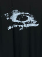 Balenciaga short-sleeve T-shirt detail: distressed logo print on black fabric
