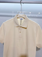 Burberry short-sleeve polo shirt in light cream, close-up of collar and button placket