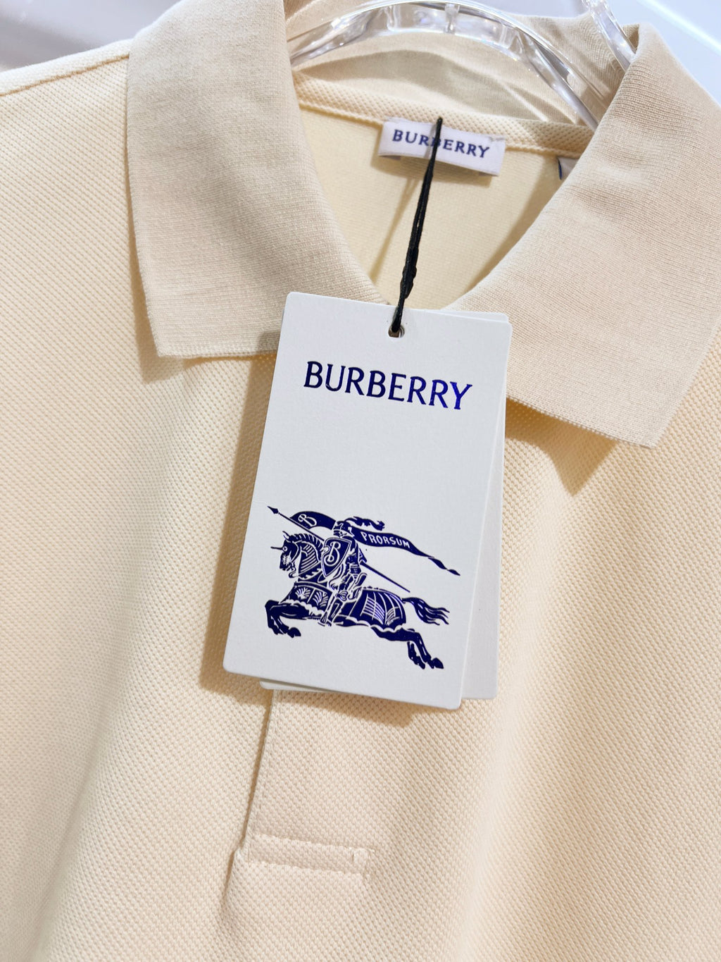 Burberry short-sleeve polo shirt in light cream, neckline fabric with hanging tag